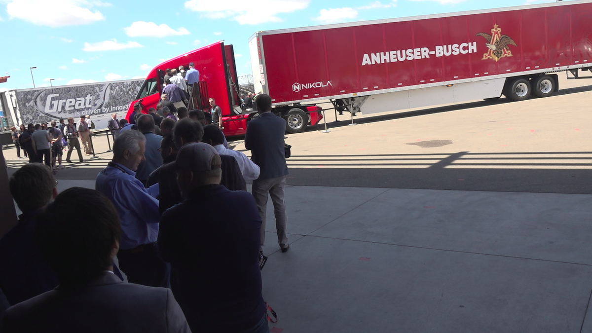 Visitors look at the Nikola Two cab.   