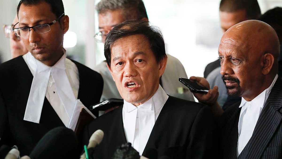 Hisyam Teh Poh Teik, center, and Naran Singh, right, lawyers for Vietnamese Doan Thi Huong speak during a press conference after court hearing at Shah Alam High Court in Shah Alam, Malaysia, Monday, April 1, 2019. (AP Photo/Vincent Thian)