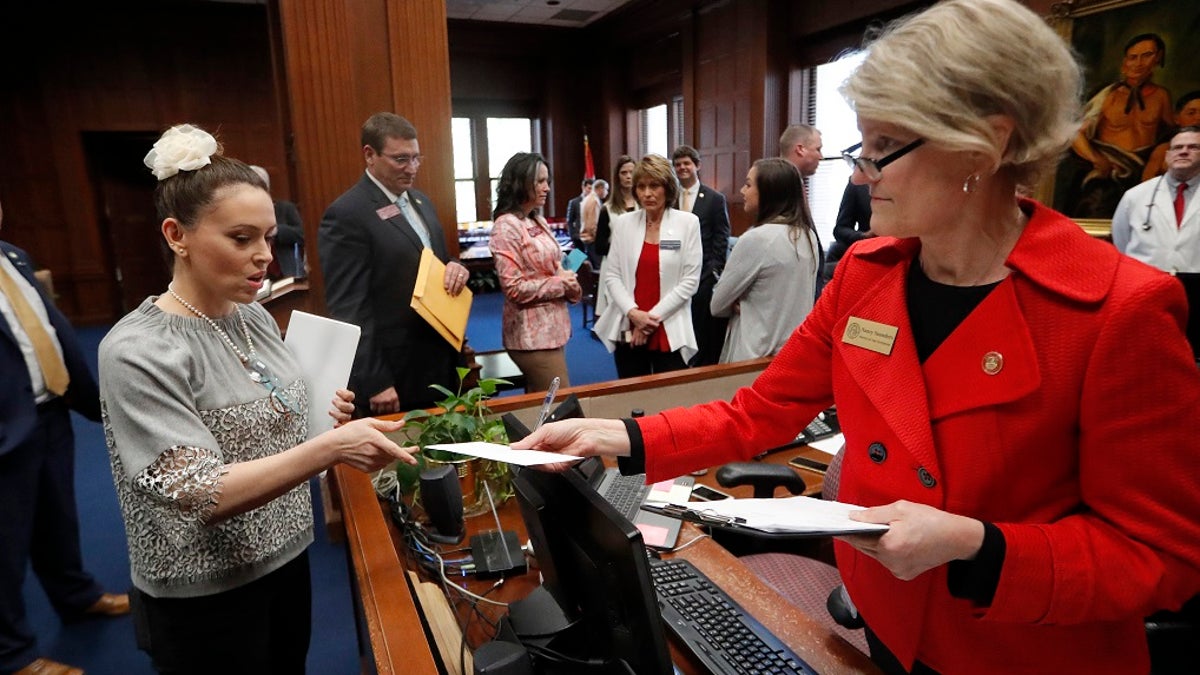 Actress Alyssa Milano, left, delivers a letter to Georgia Gov. Brian Kemp's office detailing her opposition to HB 481 at the State Capitol Tuesday, April 2, 2019, in Atlanta. HB 481 would ban almost all abortions after a fetal heartbeat can be detected. (Associated Press)