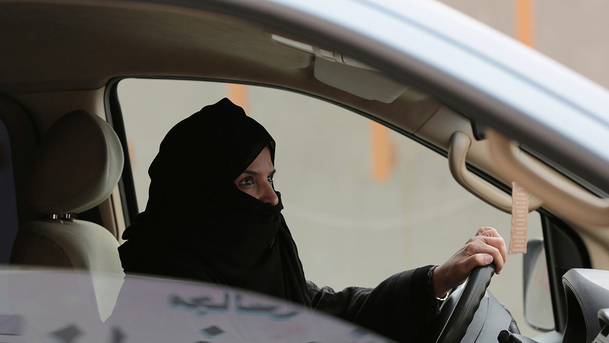 FILE - In this March 29, 2014 file photo, Aziza al-Yousef drives a car on a highway in Riyadh, Saudi Arabia, as part of a campaign to defy Saudi Arabia's then ban on women driving. Nearly a dozen Saudi women's rights activists, most of them imprisoned, have attended their third court session Wednesday, April 3, 2019, and were told their trials will continue for at least two more weeks. Meanwhile, three women who were granted temporary release last week, among them al-Yousef and Eman al-Najfan, were told their next court date would take place after the Muslim holy month of Ramadan, which coincides with early June. (AP Photo/Hasan Jamali, File)