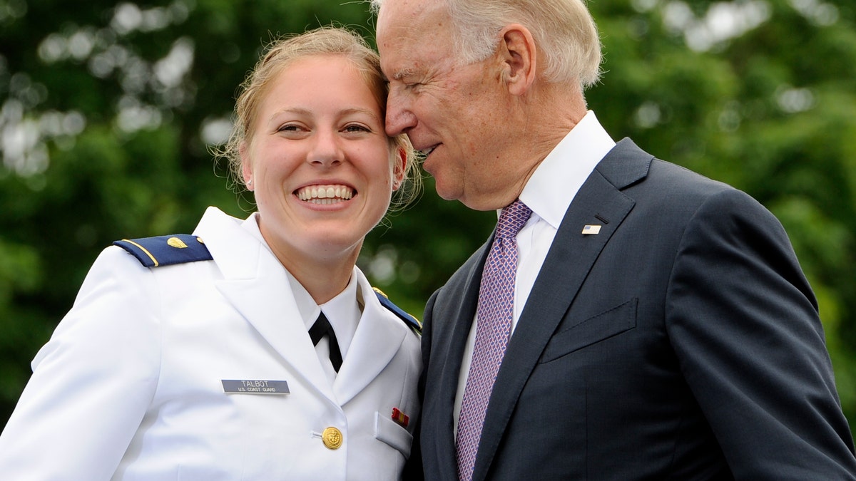 FILE - In this May 22, 2013 file photo, Newly commissioned officer Erin Talbot, left, poses for a photograph with Vice President Joe Biden during commencement for the United States Coast Guard Academy in New London, Conn. AP Photo/Jessica Hill)