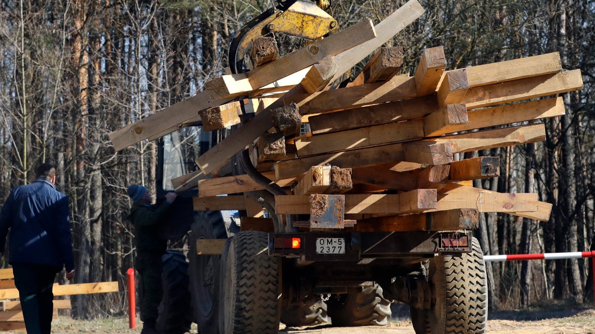 Wooden crosses dismantled at the Kuropaty mass grave site of a Soviet-era mass execution, lie in the back of a truck in the Belarus capital Minsk, Thursday, April 4, 2019.