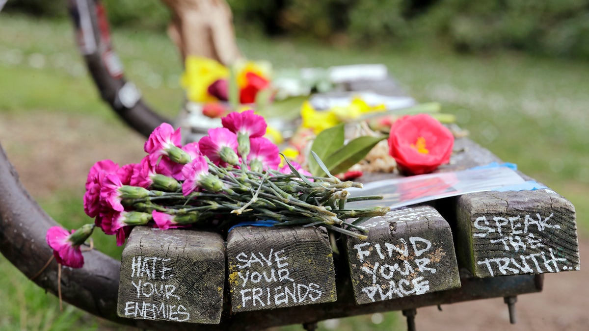 People gathered throughout the day at Viretta Parkin in Seattle on Friday, leaving flowers, candles and written messages on the 25th anniversary of Kurt Cobain's death.