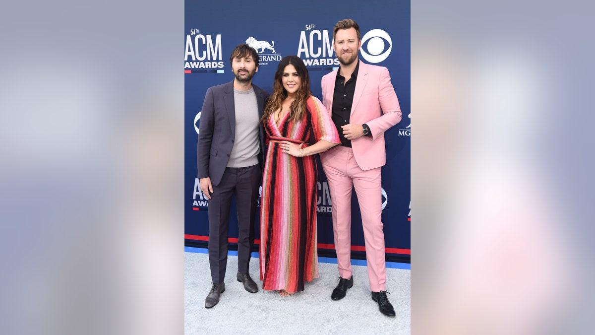 Dave Haywood, Hillary Scott and Charles Kelley of Lady Antebellum strike a pose on the 2019 ACMs red carpet.