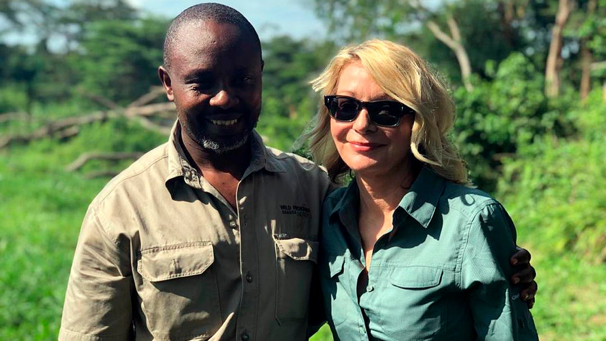 Image released by Wild Frontiers tour company on Monday April 8, 2019, shows American tourist Kim Endicott, right, and field guide Jean-Paul Mirenge a day after they were rescued following a kidnap by unknown gunmen in Uganda's Queen Elizabeth National Park. Ugandan police said on Sunday they had rescued Endicott, an American tourist, and her guide, Mirenge, who had been kidnapped by gunmen in a national park. (Wild Frontiers via AP)