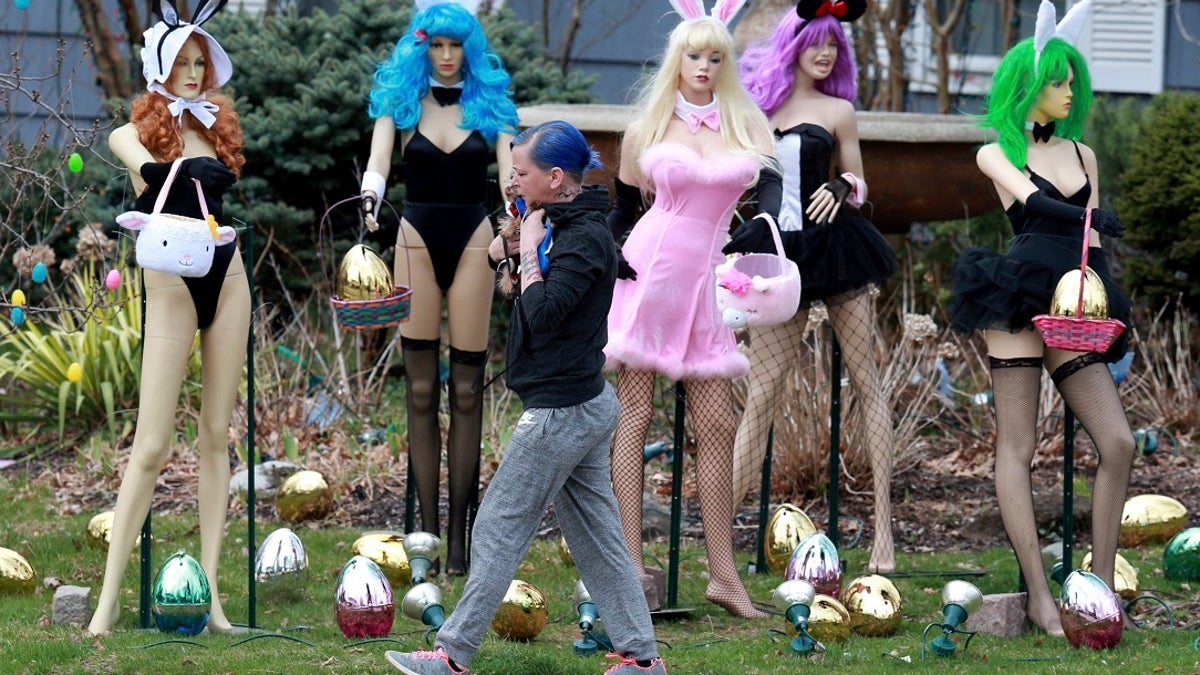 A New Jersey woman unhappy with her neighbor's racy Easter display used some garden shears to damage it. The display at a dental office in Clifton featured five mannequins dressed in lingerie, all holding Easter baskets and surrounded by Easter eggs. (Ed Murray/NJ Advance Media via AP)