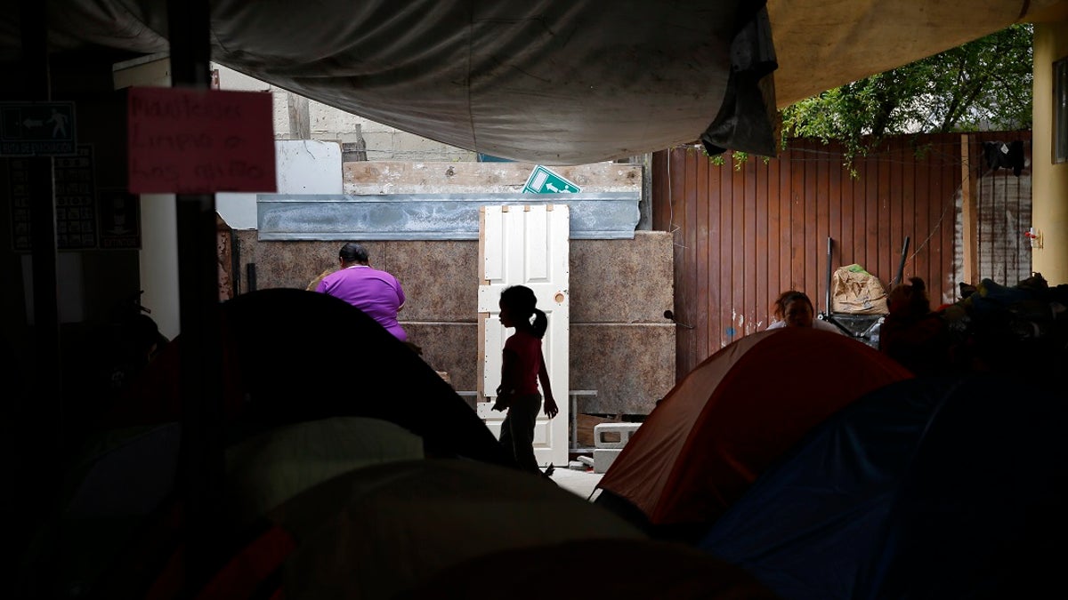 A girl from the Mexican state of Guerrero passes rows of tents as her family waits at a shelter of mostly Mexican and Central American migrants to begin the process of applying for asylum Friday, April 12, 2019, in Tijuana, Mexico. (Associated Press)