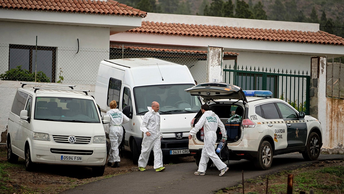 Members of the Spanish Civil Guard work on a road leading to a cave at the base of the Teide volcano, where a mother and son were found in Santa Cruz de Tenerife in the Canary Islands, Spain, Wednesday, April 24, 2019. 