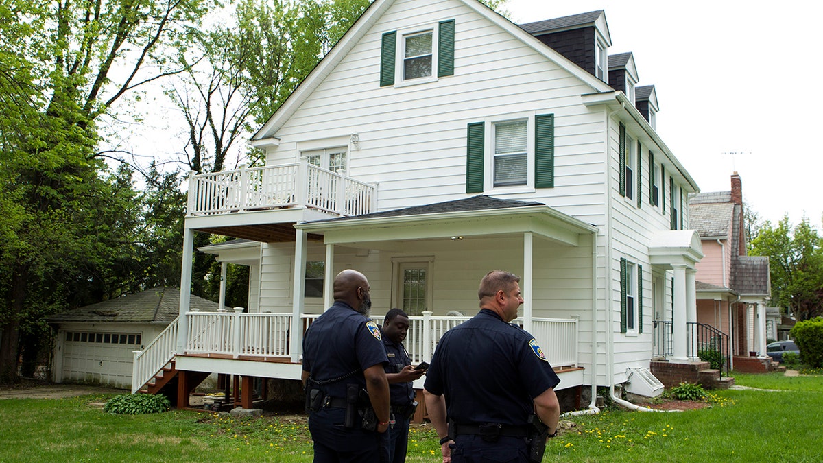 Baltimore police officers stand outside the house of Baltimore Mayor Catherine Pugh in Baltimore, MD., Thursday, April 25, 2019. Agents with the FBI and IRS are gathering evidence inside the two homes of Pugh and also in City Hall. (AP Photo/Jose Luis Magana)