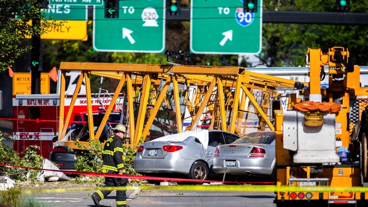 Emergency crews work the scene of a construction crane collapse near the intersection of Mercer Street and Fairview Avenue near Interstate 5 in Seattle.