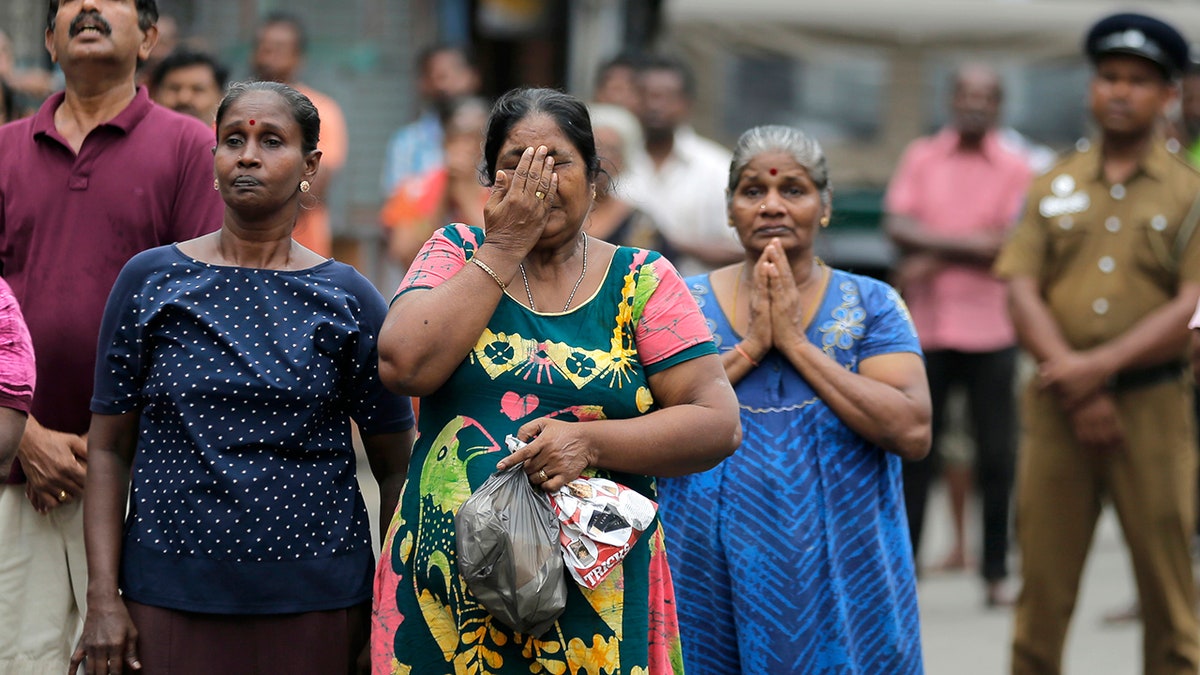 Sri Lankan Catholics pray standing on a road as they attend a brief holly service marking the seventh day of the Easter Sunday attacks near the exploded St. Anthony's Church in Colombo, Sri Lanka, Sunday, April 28, 2019. (AP Photo/Eranga Jayawardena)
