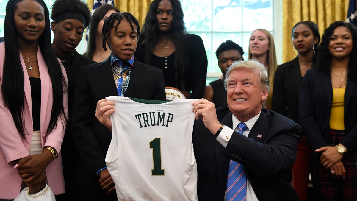 Trump holds jersey