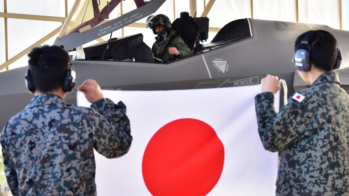 Japanese military holding the flag of Japan