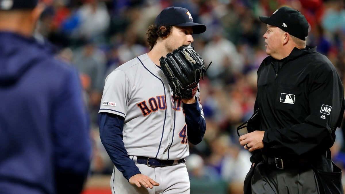 Pitcher Gerrit Cole and home plate umpire Ron Kulpa exchange words during the seventh inning.