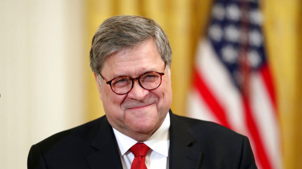 Attorney General William Barr smiles as he waits for President Donald Trump to speak at the 2019 Prison Reform Summit and First Step Act Celebration in the East Room of the White House in Washington, Monday, April 1, 2019. (AP Photo/Andrew Harnik)