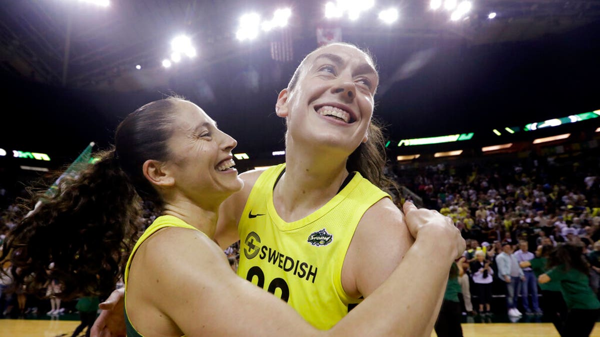 FILE - In this Sept. 4, 2018, file photo, Seattle Storm's Breanna Stewart, right, is embraced by Sue Bird after the Storm defeated the Phoenix Mercury 94-84 during Game 5 of a WNBA basketball playoff semifinal, in Seattle. The WNBA's 23rd season begins May 24, with the Seattle Storm the defending champion. (AP Photo/Elaine Thompson, File)