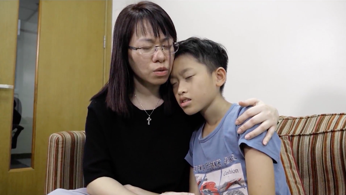 Ngocanh Le prays with her son, Minh Viet. She turned to God after found out he wanted to commit suicide amid being addicted to violent video games.