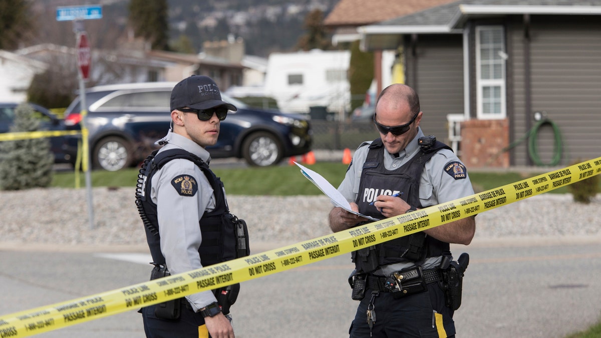 Royal Canadian Mounted Police officers work outside a scene in Penticton, British Columbia, Monday, April 15, 2019.