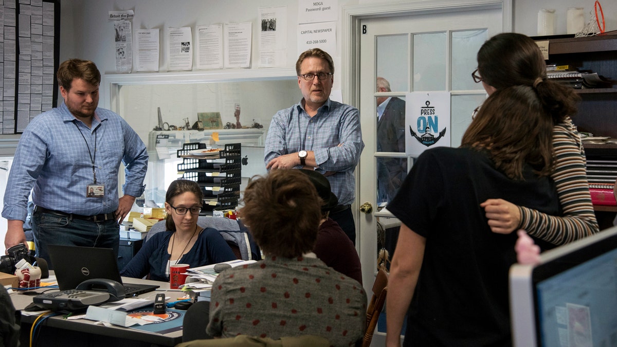 Capital Gazette Editor Rick Hutzell, center, speaks to staffers Monday as the paper won a special Pulitzer Prize citation for its coverage of a shooting that killed five of the paper's staffers. (Ulysses Muoz/The Baltimore Sun via AP)