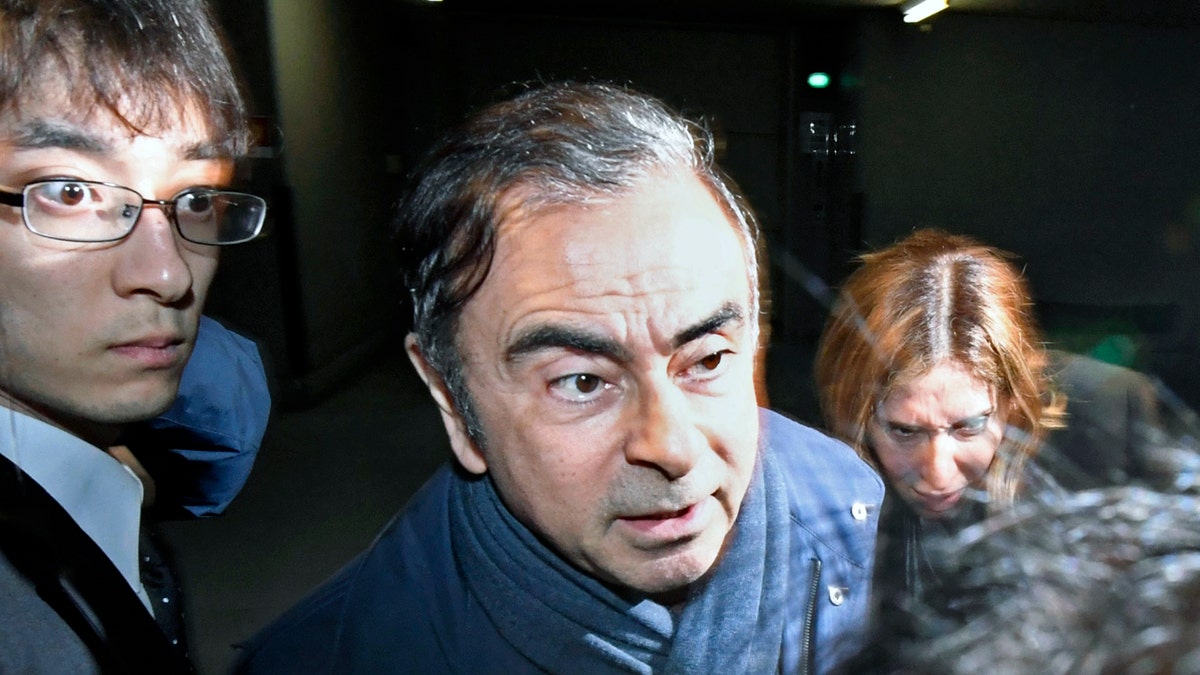 Former Nissan Chairman Carlos Ghosn, center, leaves his lawyer's office in Tokyo Wednesday. (Sadayuki Goto/Kyodo News via AP, File)