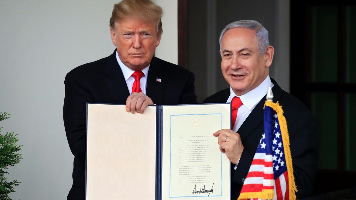 In this March 25, 2019 photo, Israeli Prime Minister Benjamin Netanyahu and President Donald Trump hold up the signed proclamation recognizing Israel's sovereignty over the Golan Heights at the White House in Washington. (AP Photo/Manuel Balce Ceneta, File)