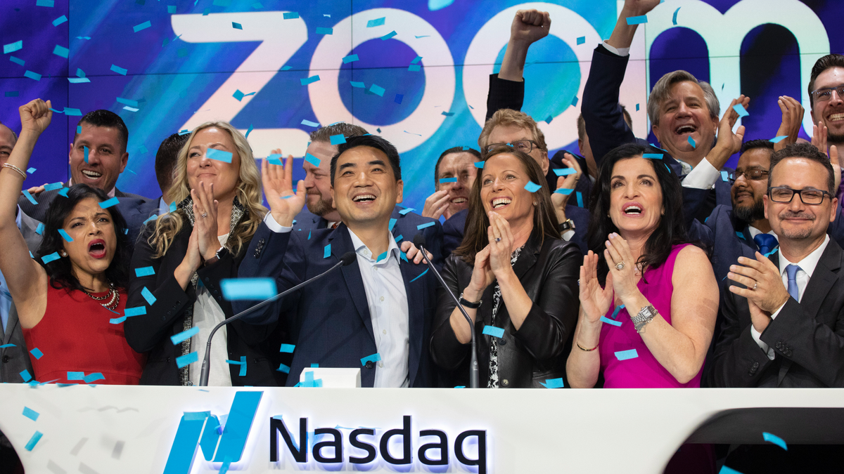 Zoom CEO Eric Yuan, center, celebrates the opening bell at Nasdaq as his company holds its IPO, Thursday, April 18, 2019, in New York. The videoconferencing company is headquartered in San Jose, Calif. - file photo.