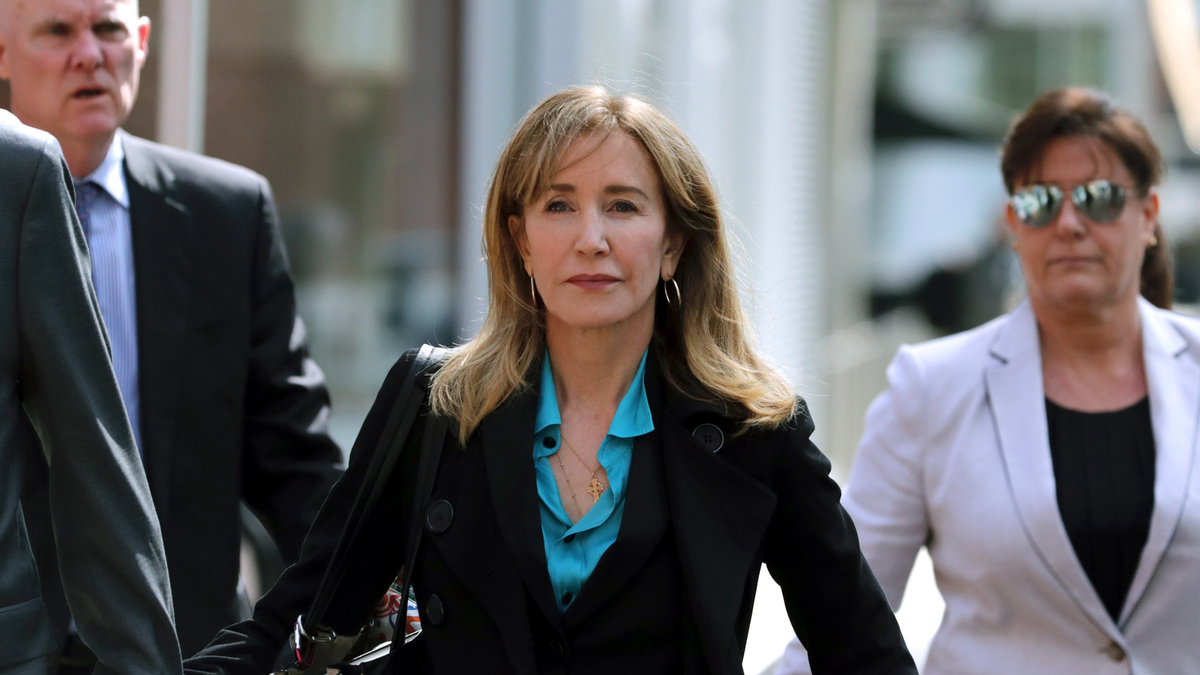 This April 3, 2019 file photo shows actress Felicity Huffman arriving at federal court in Boston to face charges in a nationwide college admissions bribery scandal. Huffman is facing a prison sentence after agreeing Monday to plead guilty to one count of conspiracy and fraud for paying a consultant $15,000 disguised as a charitable donation to boost her daughter’s SAT score. Prosecutors are seeking four to 10 months of confinement, and experts differ on whether the plea, and Huffman’s subsequent apology taking full responsibility for her actions, will lead to a career rebound or retreat. (AP Photo/Charles Krupa, File)