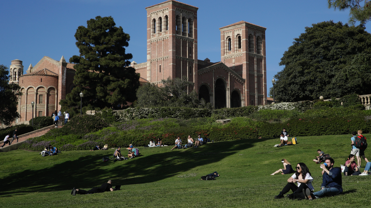 Students sit on the lawn near Royce Hall at UCLA Thursday, April 25, 2019, in the Westwood section of Los Angeles. (AP Photo/Jae C. Hong)