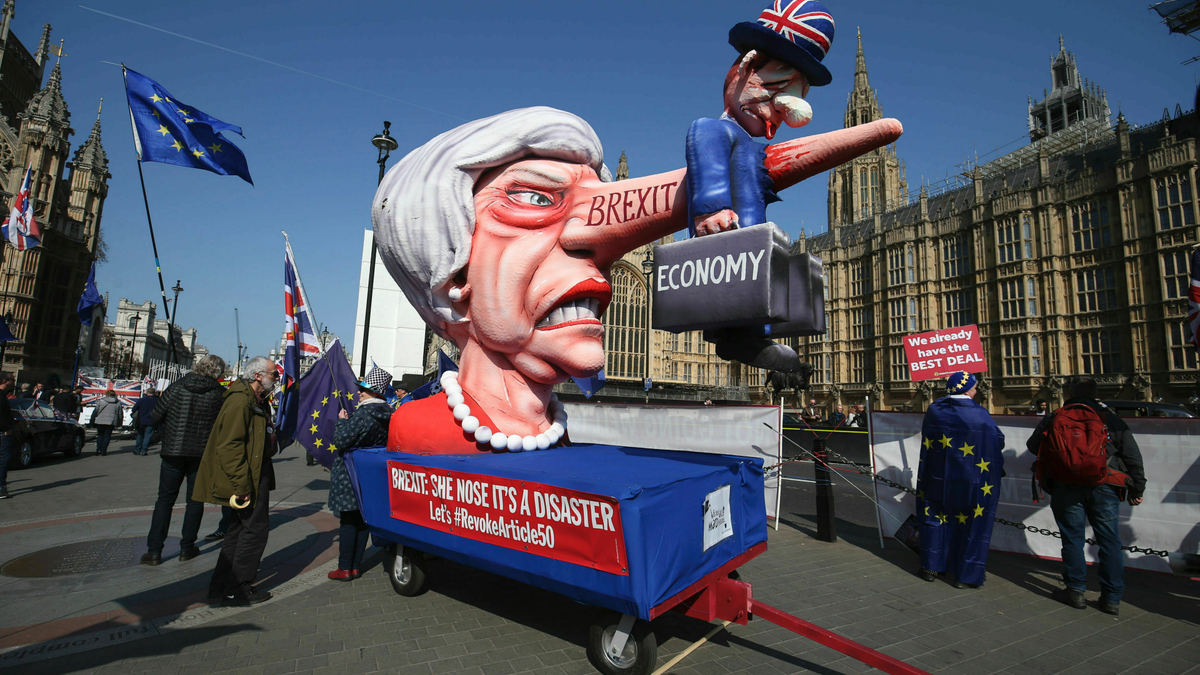 Anti-Brexit demonstrators with an effigy of British Prime Minister Theresa May near College Green at the Houses of Parliament in London, Monday, April 1, 2019. (Jonathan Brady/PA via AP)