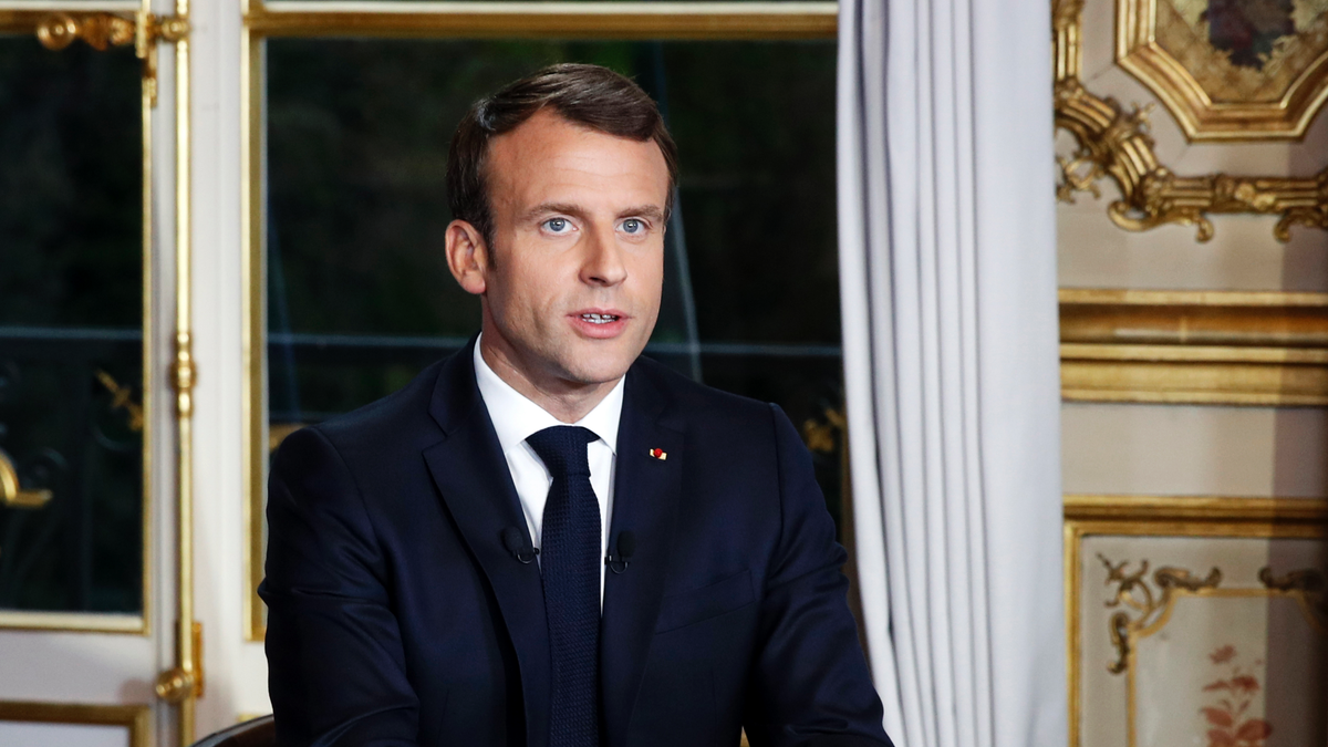 French President Emmanuel Macron sits at his desk after addressing the French nation following a massive fire at Notre Dame Cathedral, at Elysee Palace in Paris, on April 16, 2019.?