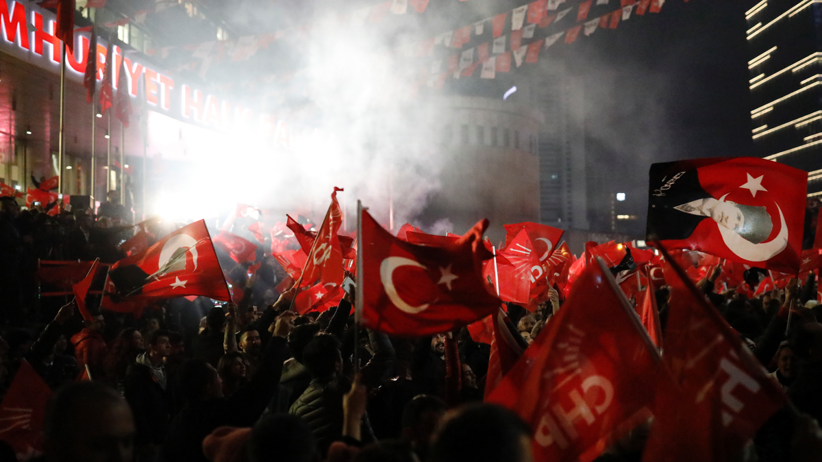 Supporters of the Republican People's Party, CHP, wave Turkish flags, and one with a portrait of Kemal Ataturk, right, as they celebrate after preliminary results of the local elections were announced in Ankara, Turkey, early Monday, April 1, 2019.