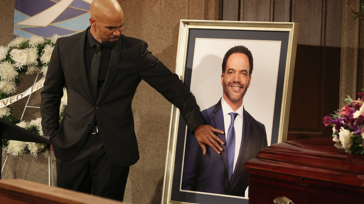 Shemar Moore, portraying Malcolm Winters, pays respects during a funeral scene for St. John's character Neil Winters.