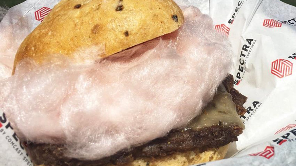 The burger includes a green chili bun, grilled Angus burger, ghost pepper cheese and a large puff of red chili cotton candy.