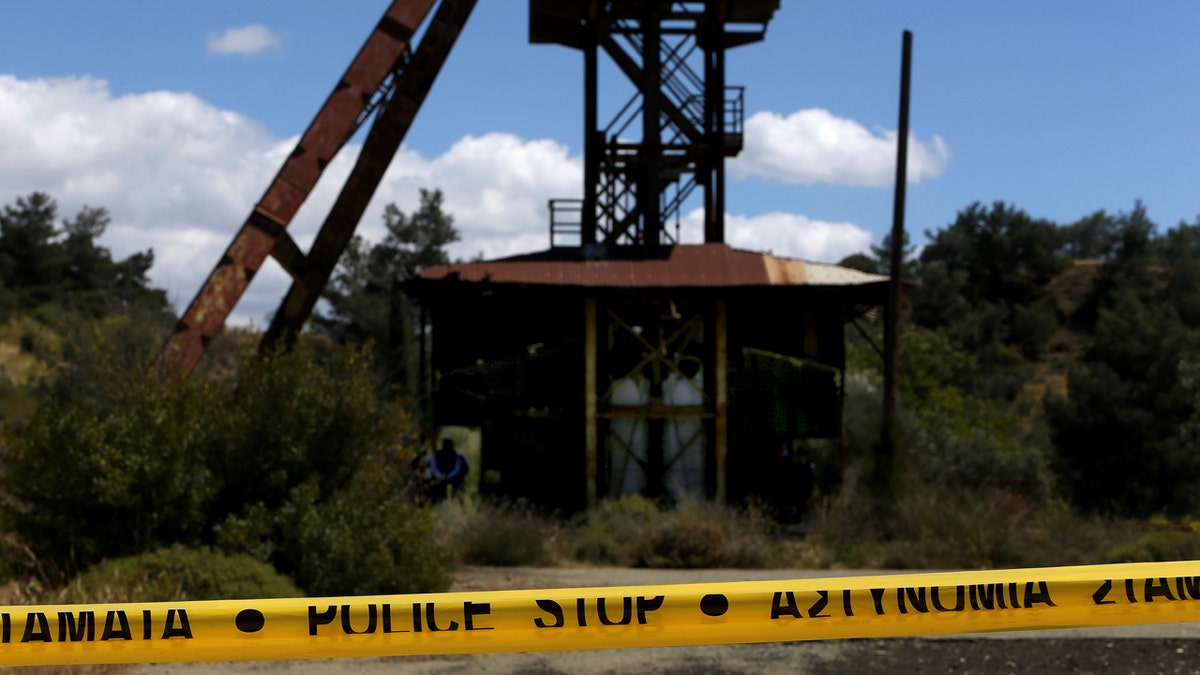 Cypriot investigators and police search a flooded mineshaft where two female bodies were found, outside Mister village near the capital Nicosia, Cyprus, Monday, April 22, 2019.