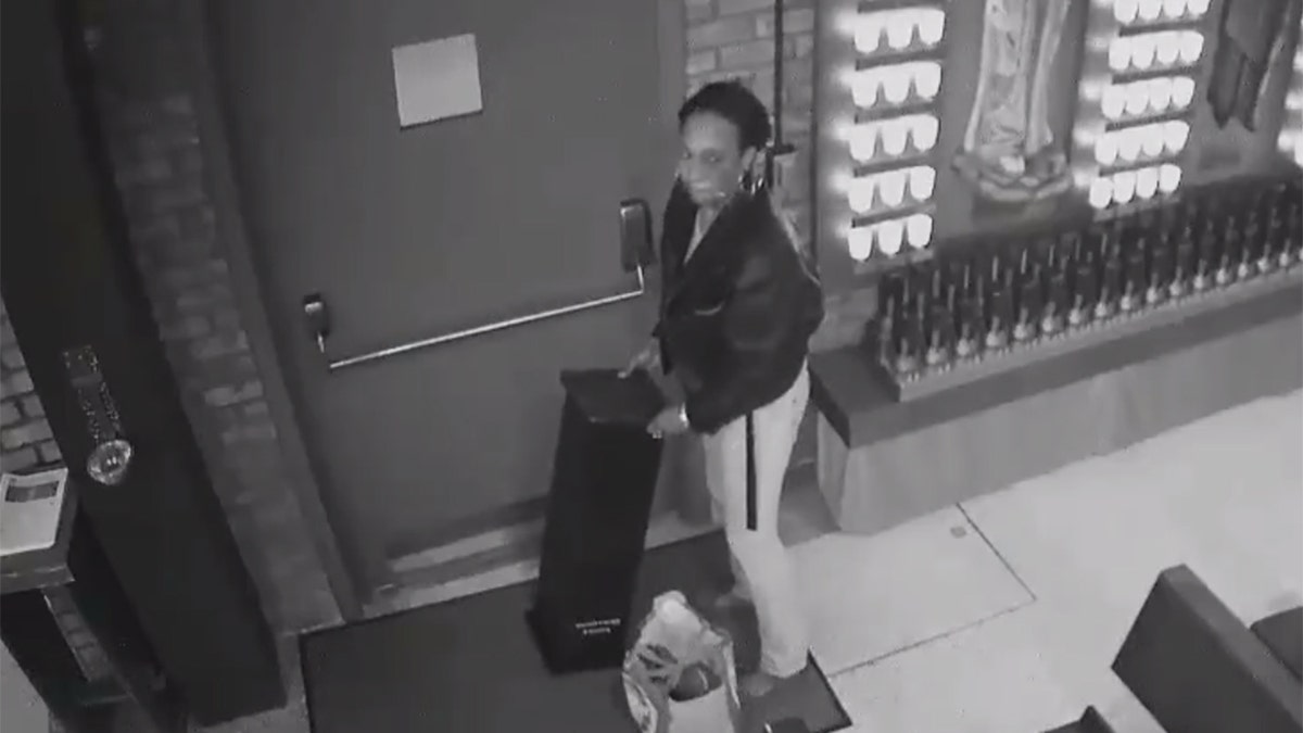 Image taken from surveillance video released by the NYPD showing a woman wanted for pilfering a donation box during a break-in at a parish church in New  York last week.