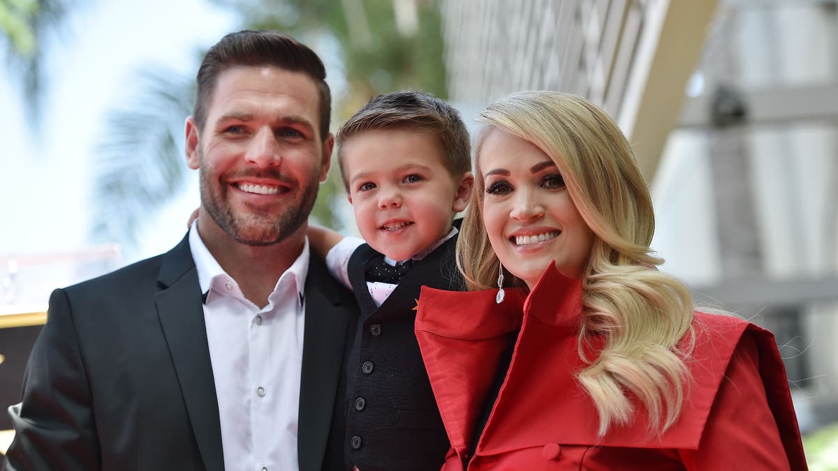 Carrie Underwood is pictured here with husband Mike Fisher and their son Isaiah at Underwood's star unveiling ceremony on the Hollywood Walk of Fame on September 20, 2018. On Sunday, the proud parents revealed how their 4-year-old son ended his Easter.