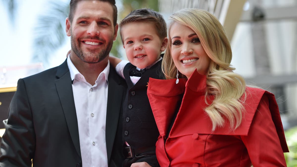 Carrie Underwood is pictured here with husband Mike Fisher and their son Isaiah at Underwood's star unveiling ceremony on the Hollywood Walk of Fame on September 20, 2018. On Sunday, the proud parents revealed how their 4-year-old son ended his Easter.