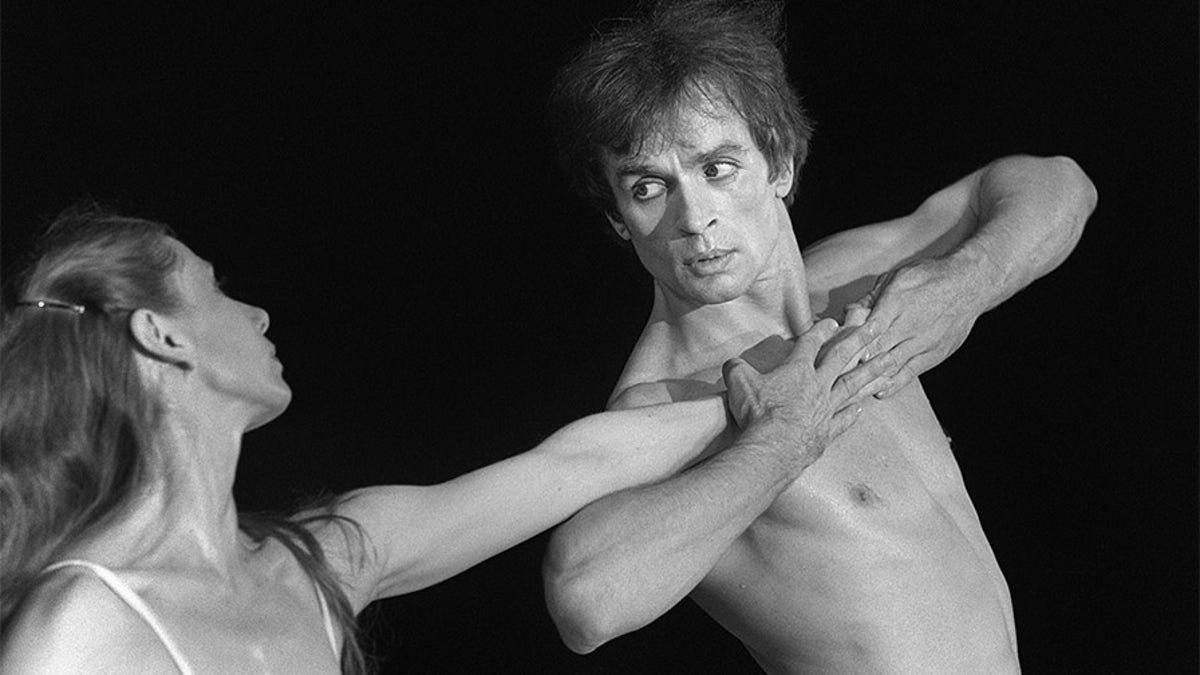 Soviet-born ballet dancer Rudolf Nureyev performs with Ghislaine Thesmar during a scene from the ballet "Afternoon of a Faun " at Le Bourget for the "Fete de la Liberté." 