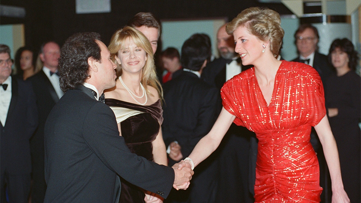 The Princess of Wales, Princess Diana, attends the Premiere of "When Harry Met Sally..." in London's West End. The Princess, wearing a Bruce Oldfield red chiffon dress embroidered in a tartan design in silver Lam, talks to American actors Meg Ryan and actor Billy Crystal who star in the film, 30th November 1989. —?Photo by Kent Gavin/Daily Mirror/Mirrorpix/Getty Images