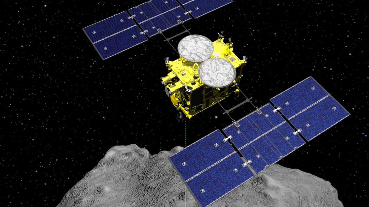 In this computer graphics image released by the Japan Aerospace Exploration Agency (JAXA), the Hayabusa2 spacecraft is seen above the asteroid Ryugu.