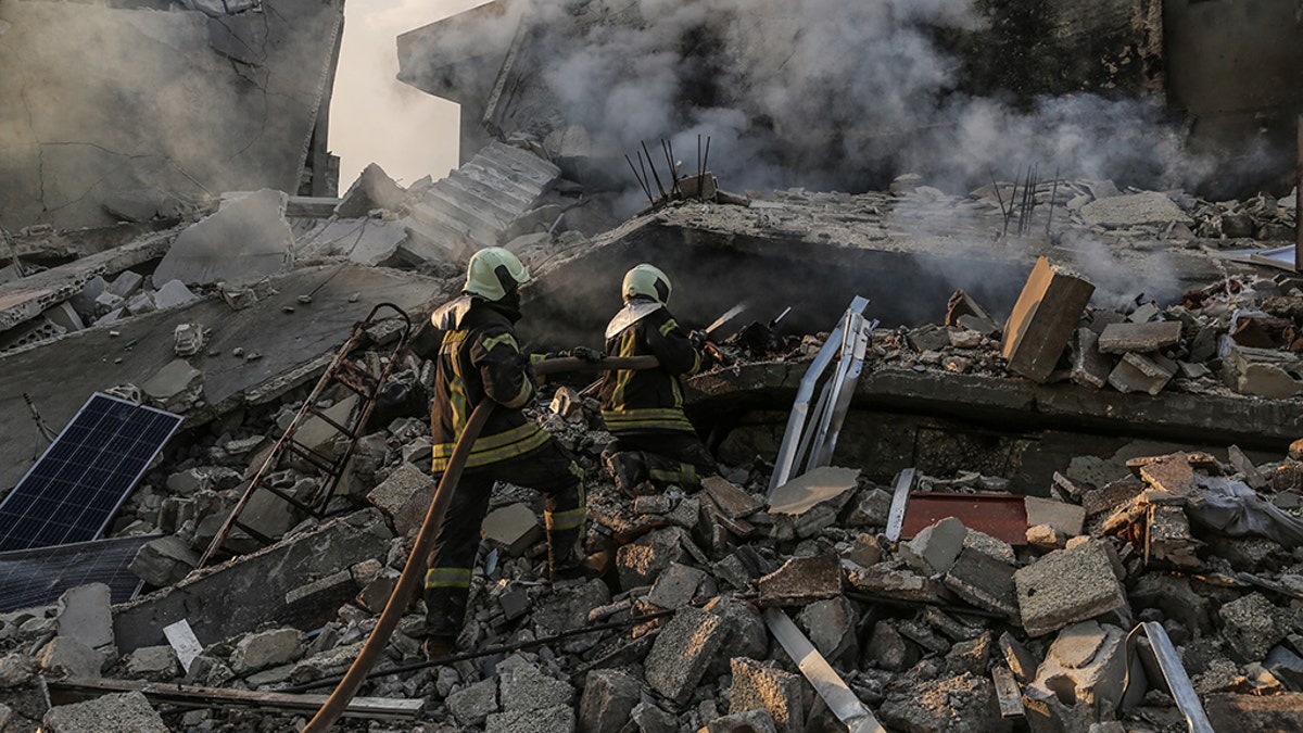 22 March 2019, Syria, Idlib: Members of the Syrian civil defense extinguish a fire in a house allegedly targeted by an airstrike in the town of Kafraya in the north of Idlib. According to activists 10 people died in airstrikes allegedly carried out by Russian warplanes.