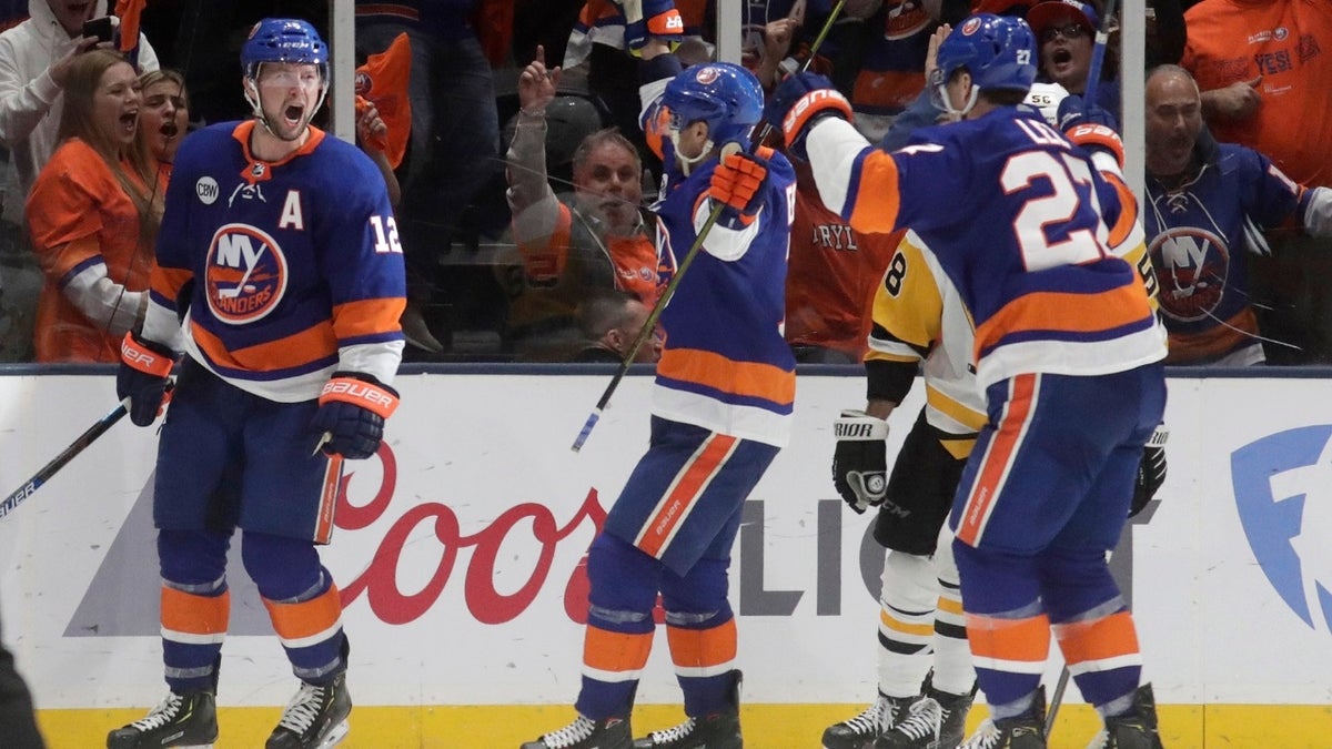 New York Islanders right wing Josh Bailey (12) celebrates his third-period goal with teammates during Game 2 of an NHL hockey first-round playoff series against the Pittsburgh Penguins, Friday, April 12, 2019, in Uniondale, N.Y.