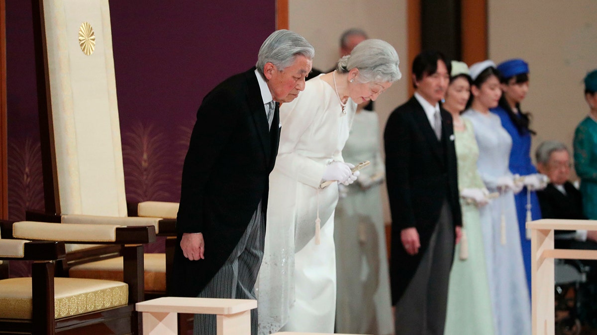 Japan's Emperor Akihito, left, and Empress Michiko, second left, bow as they prepare to leave after the ceremony of his abdication at the Imperial Palace in Tokyo, Tuesday. (Japan Pool via AP)