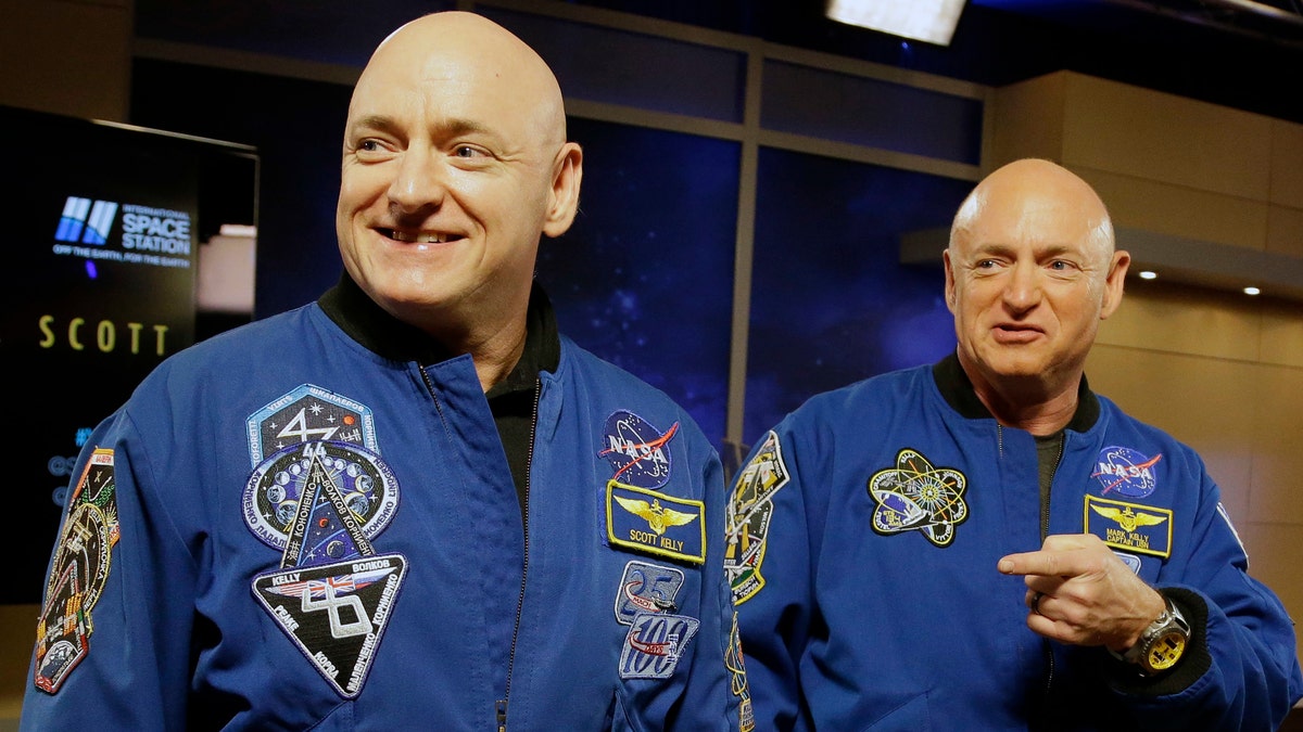 In this March 4, 2016 file photo, NASA astronaut Scott Kelly, left, and his identical twin, Mark, stand together before a news conference in Houston.