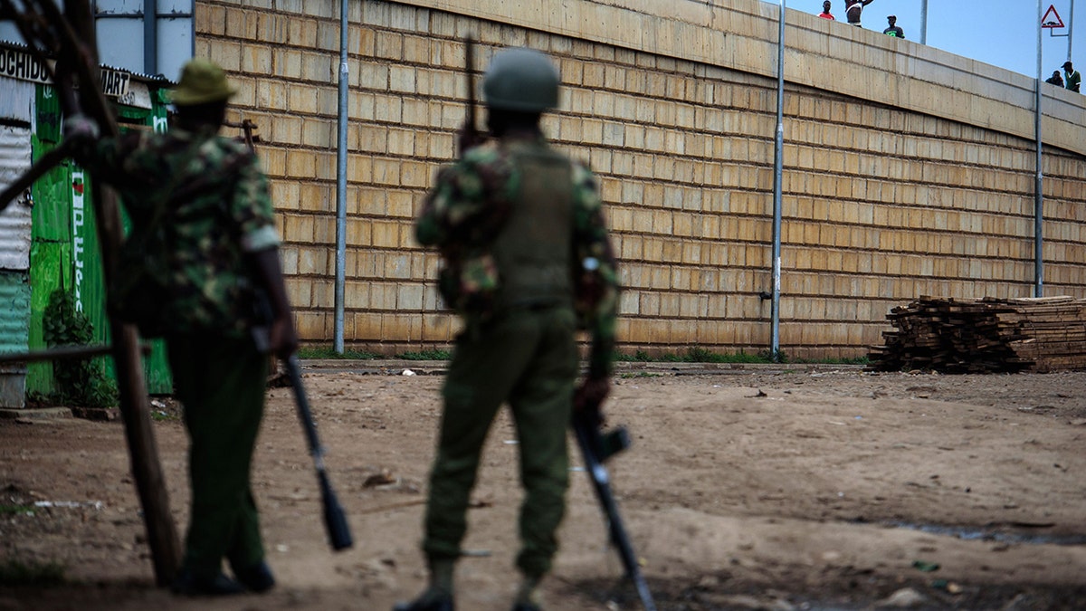 Protesters face anti-riot police on October 25, 2017 in the Kondele district of Kisumu, an opposition stronghold in western Kenya, a day before the scheduled repeat presidential poll. (Photo credit should read JENNIFER HUXTA/AFP/Getty Images)