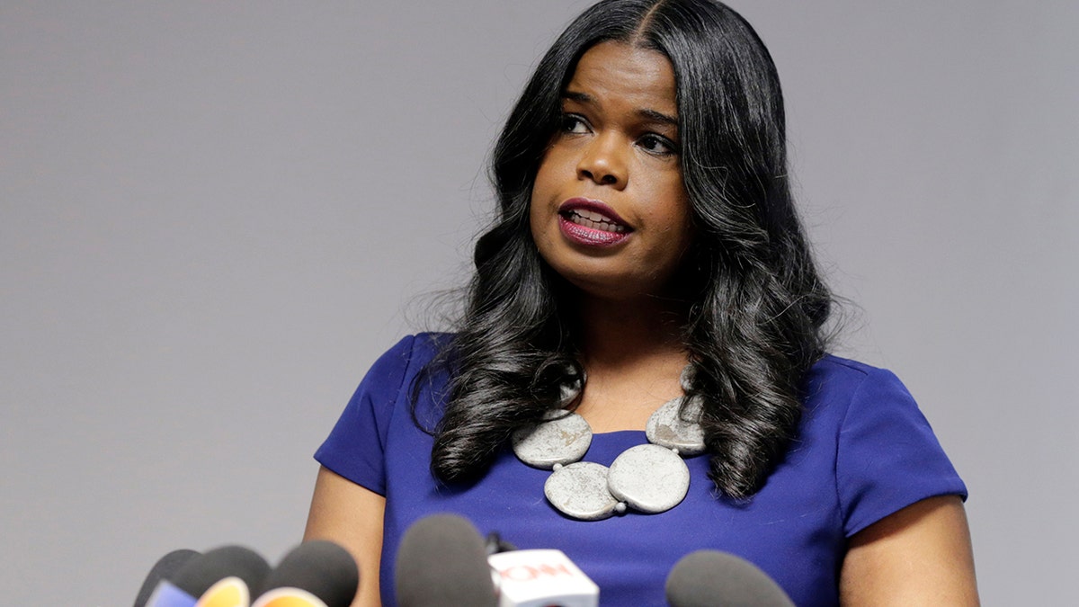Kim Foxx, Cook County state's attorney, in a blue shirt speaking before microphones