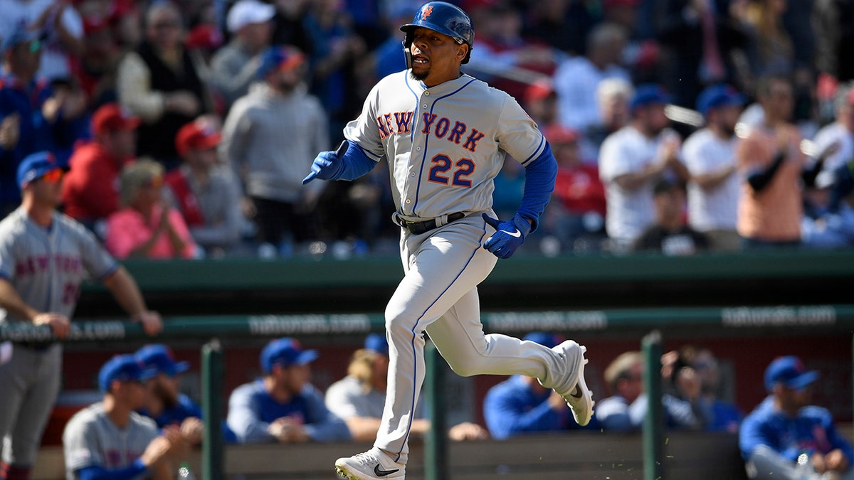 New York Mets' Dominic Smith runs toward home to score on a single by Robinson Cano during the eighth inning of a baseball game against the Washington Nationals, Thursday, March 28, 2019, in Washington.