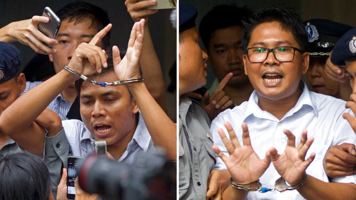 FILE: Reuters journalists Kyaw Soe Oo, left, and Wa Lone, are handcuffed as they are escorted by police out of a court in Yangon, Myanmar. 