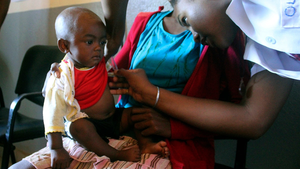 A volunteer nurse examines 6-moth-old Sarobidy, who is infected with measles, while her mother Nifaliana Razaijafisoa looks on, at a health care center in Larintsena, Madagascar, on March 21, 2019. The island nation faces its largest measles outbreak in history and cases soar well beyond 115,000. (AP Photo/Laetitia Bezain)