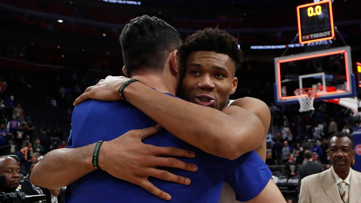 Milwaukee Bucks forward Giannis Antetokounmpo, front right, hugs Detroit Pistons center Zaza Pachulia after Game 4 of a first-round NBA basketball playoff series, Monday, April 22, 2019, in Detroit. (AP Photo/Carlos Osorio)